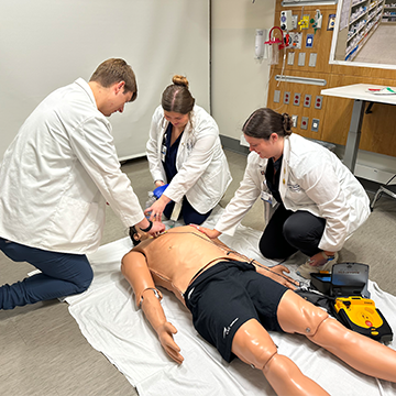 Students working on a simulation dummy