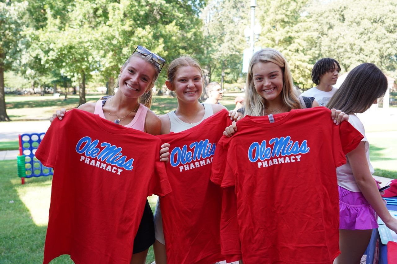 students posing with T-Shirts