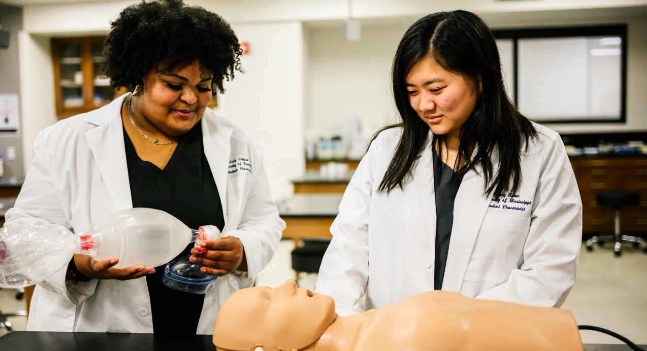 Student practicing on a breathing dummy.