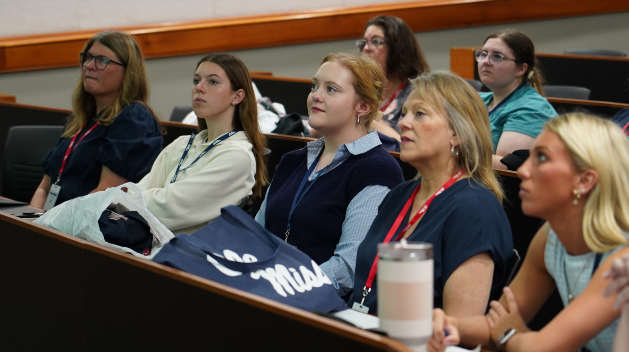 Students and parents listening to pharmacy programming at orientation