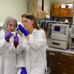 Pharmaceutics graduate students Tabish Mehraj (left) and Corinne Sweeney (right) work with equipment that will be integral to the new Master’s of Industrial Pharmacy program.