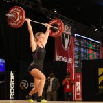 Emily Lewis lifting a weight above her head