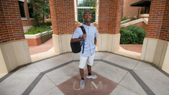 Male student Brandon Ashmore poses with backpack on shoulder