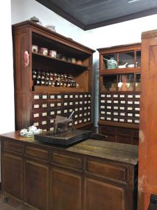 Image of wooden cabinets and drawers with Chinese/Western medicine