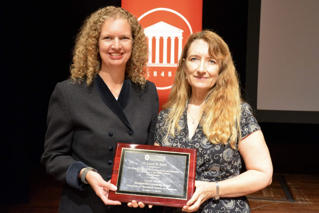 Kristie Willett presents Laura Bohn an award plaque