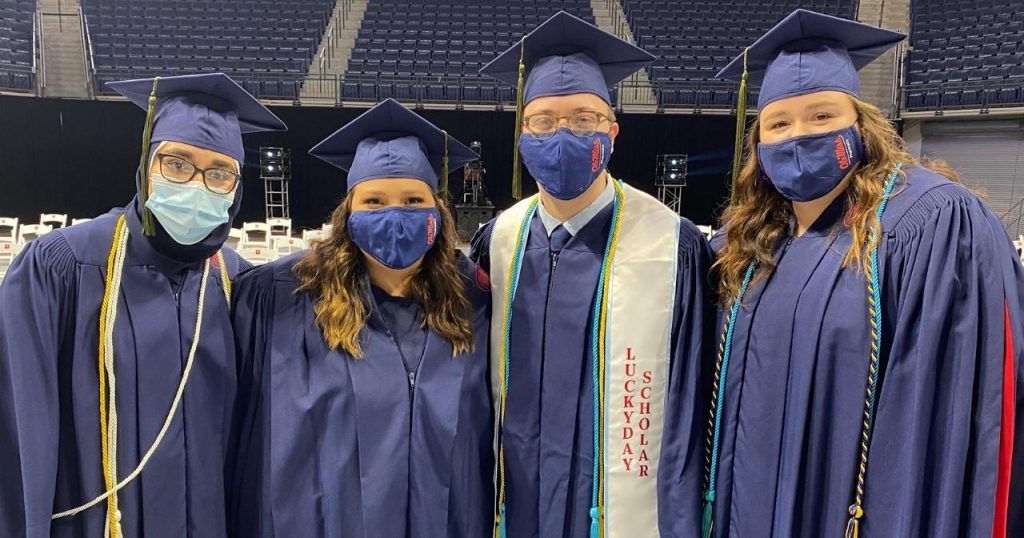 Four students at the School of Pharmacy commencement ceremony